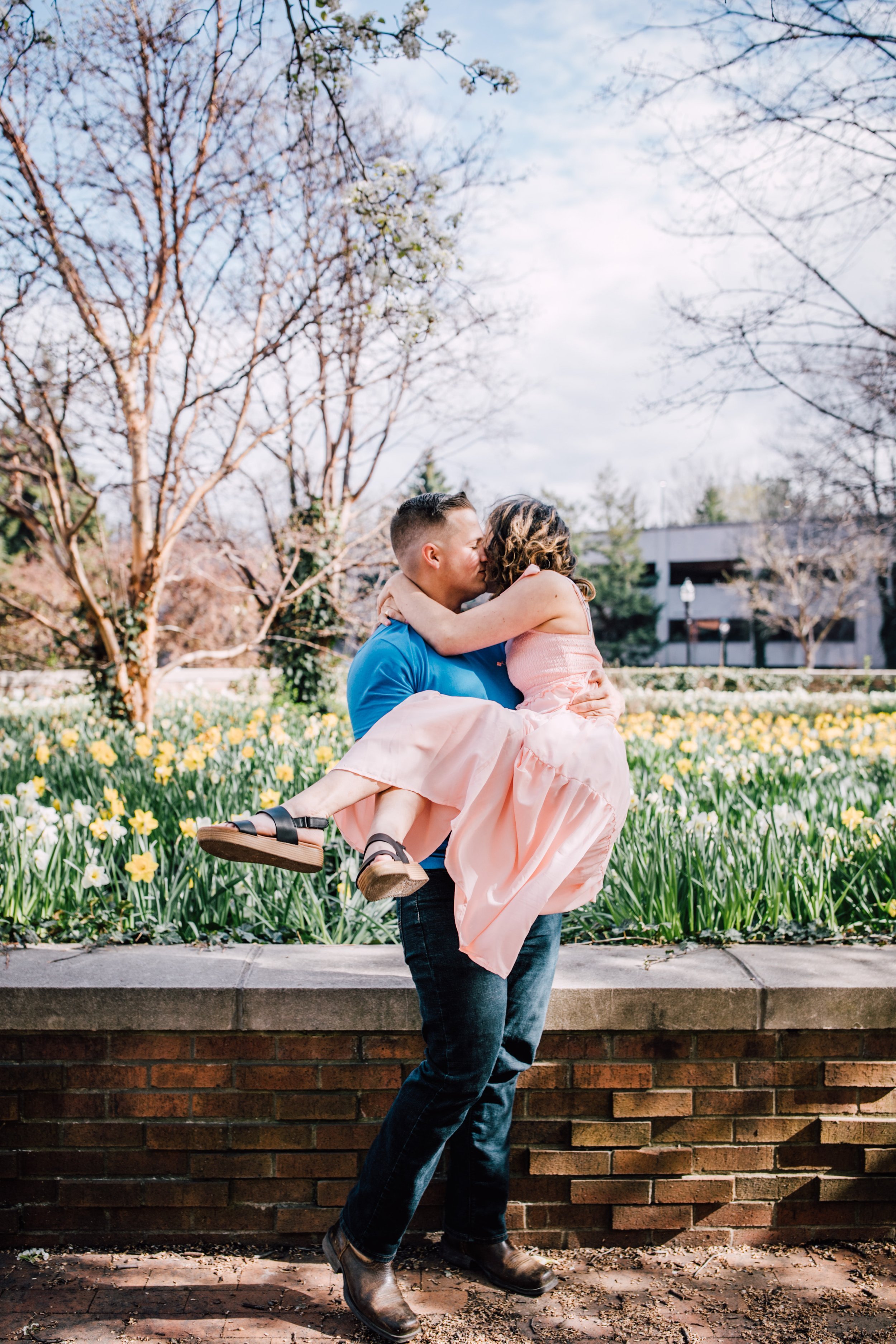  engaged man lifts his fiancee in franklin square park syracuse 