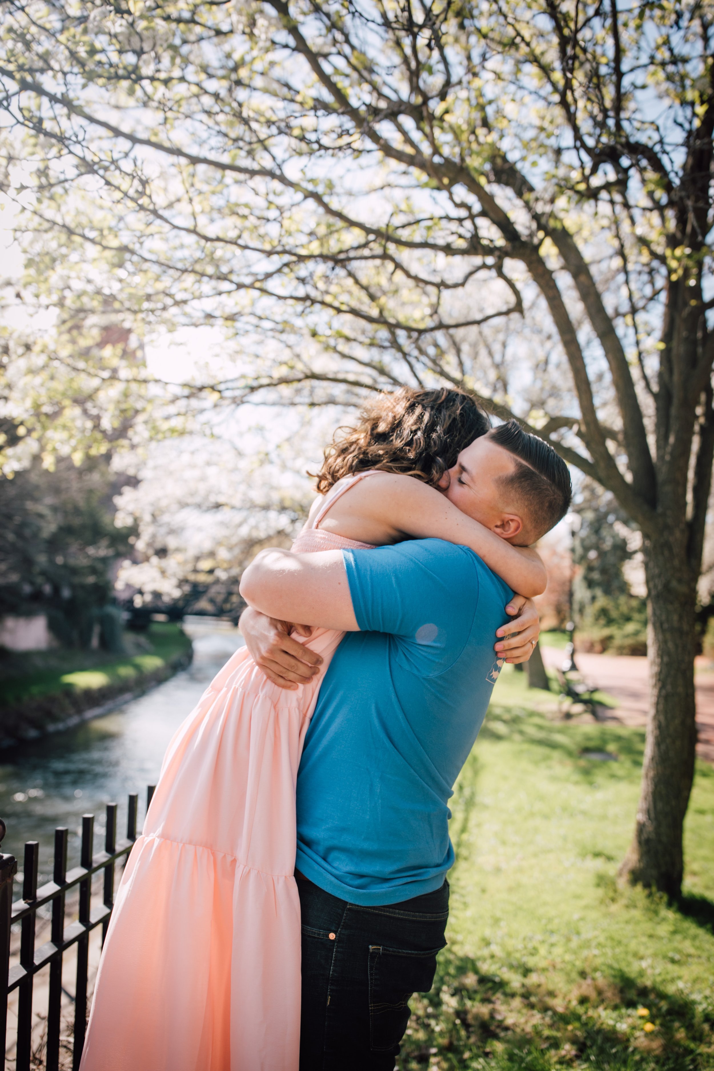  engaged man lifts his fiancee in an embrace in downtown syrause ny 