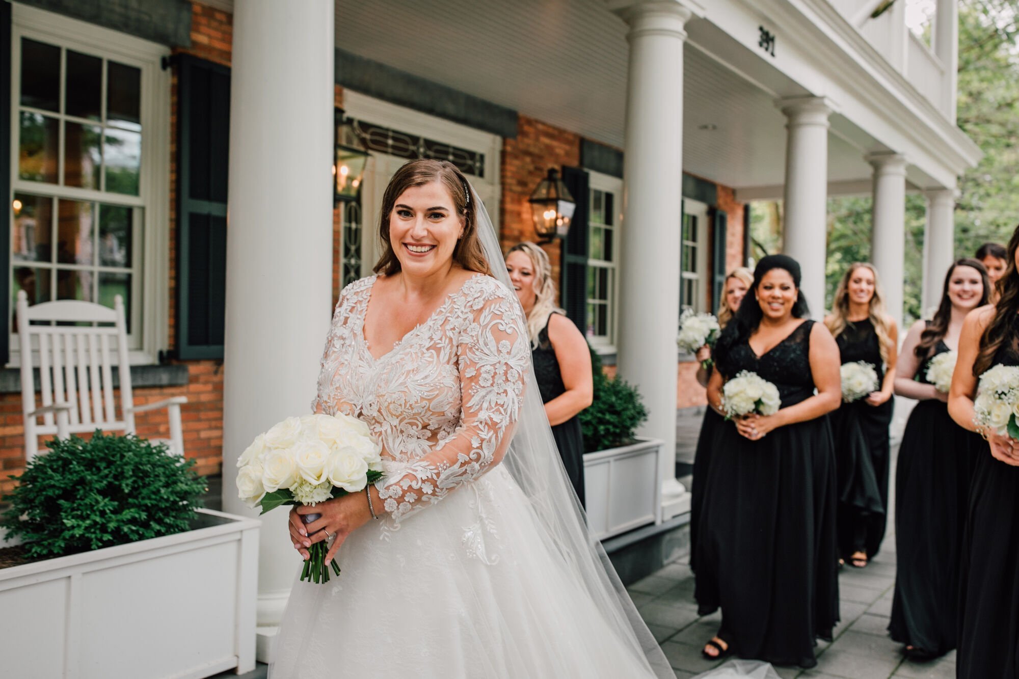  finger lakes wedding photographer captures a bride smiling on her way to the church with her bridesmaids&nbsp; 