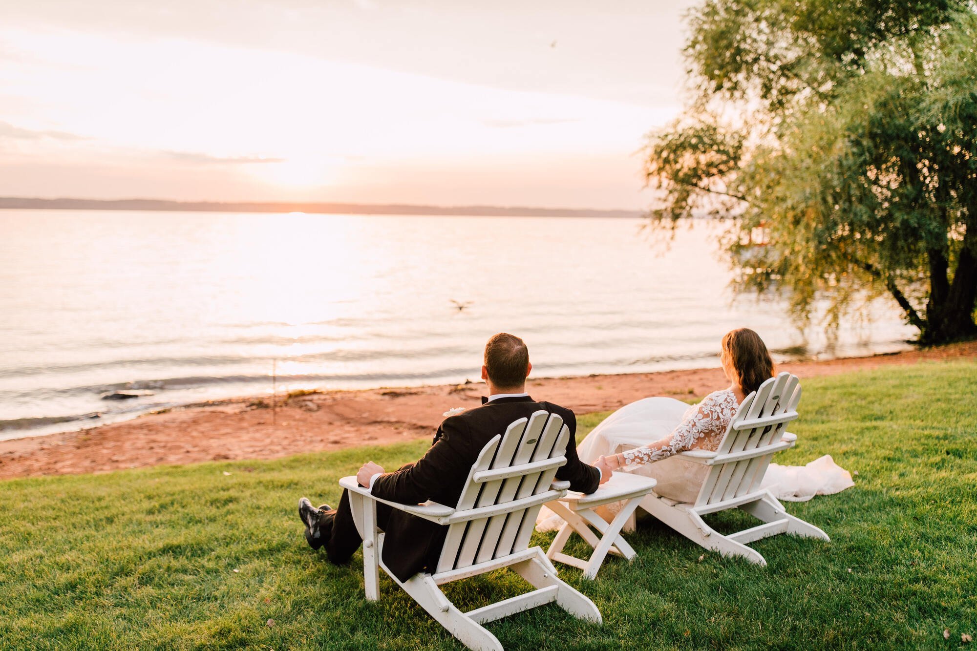  Bride and groom look over the lake during their sunset photos at finger lakes wedding 