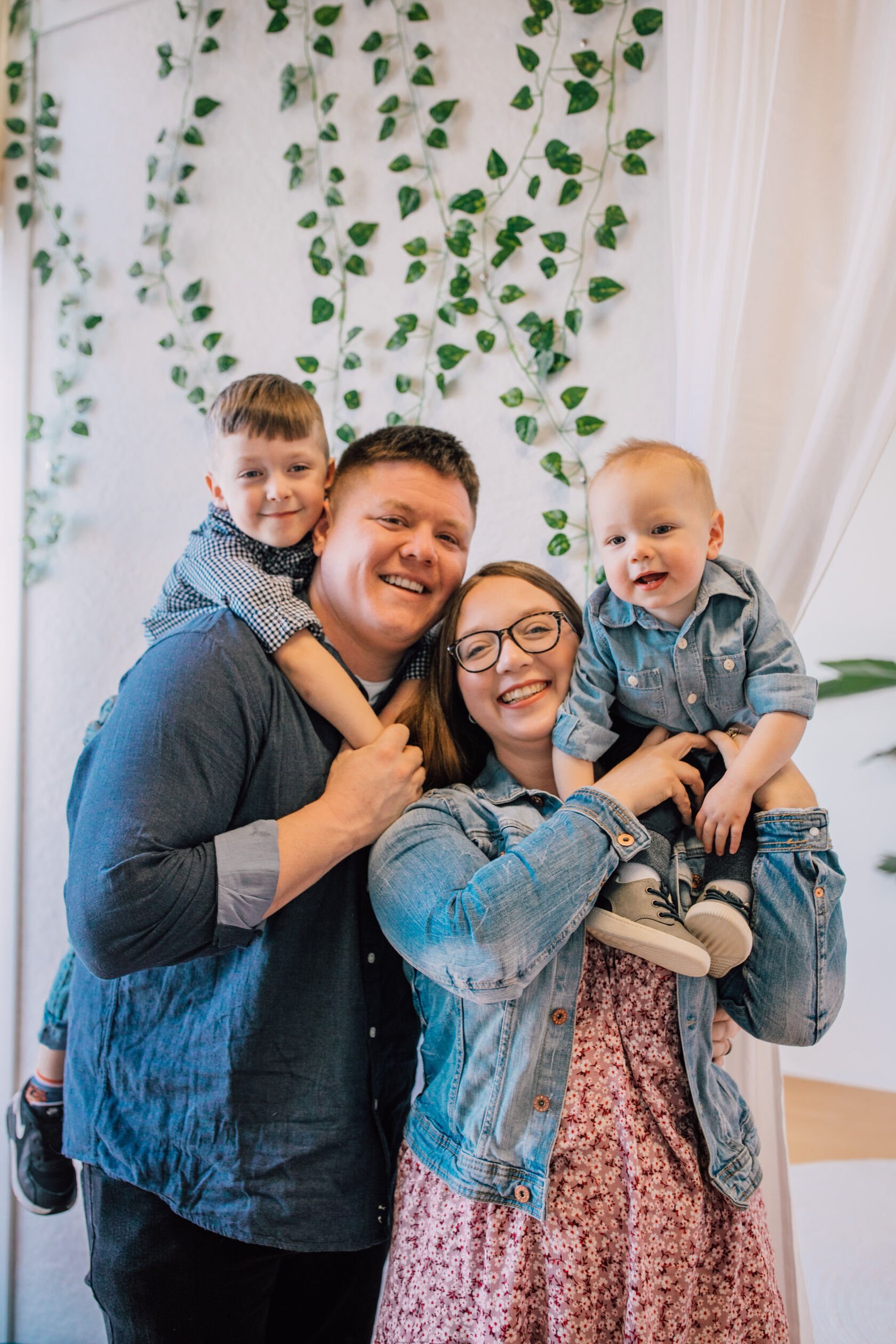  mom, dad, and two boys smile during family mini sessions 