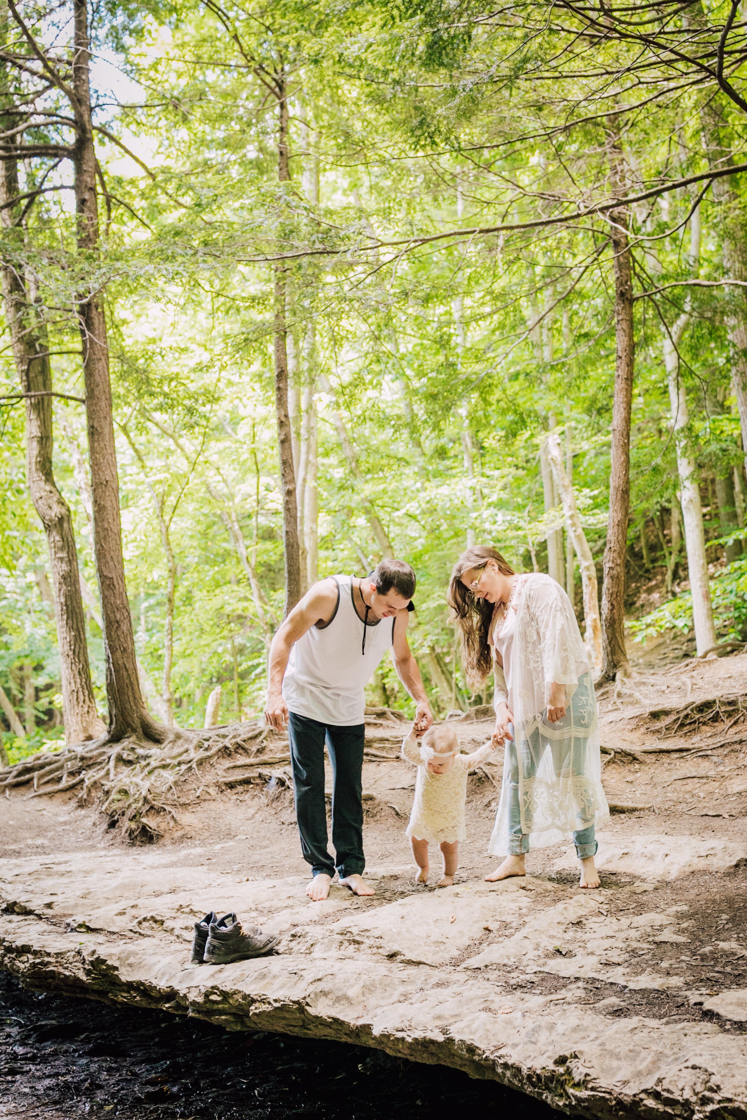  Family adventure photoshoot features a family of three holding hands 