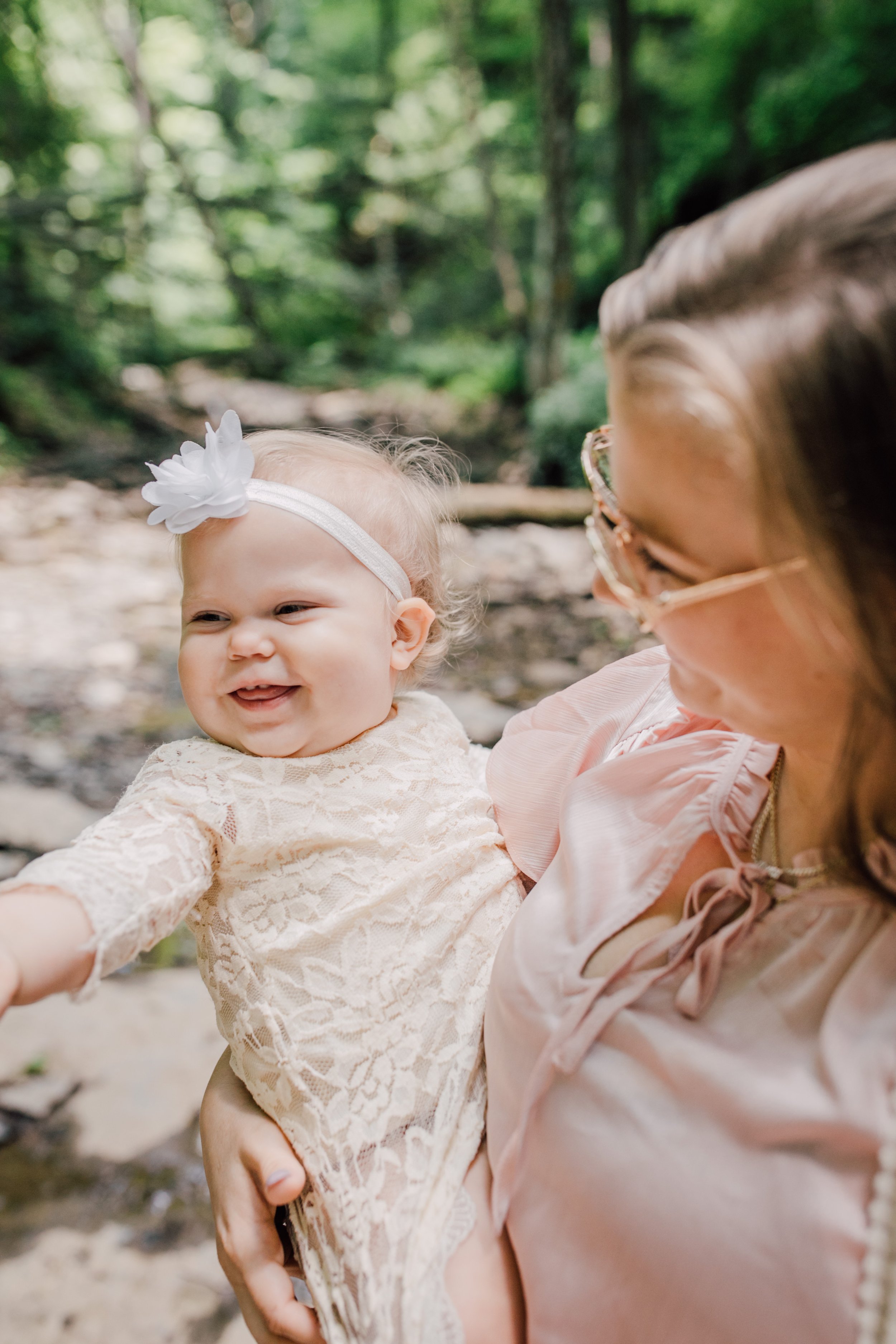  Mama holds a smiling baby girl at their tinker falls photoshoot 