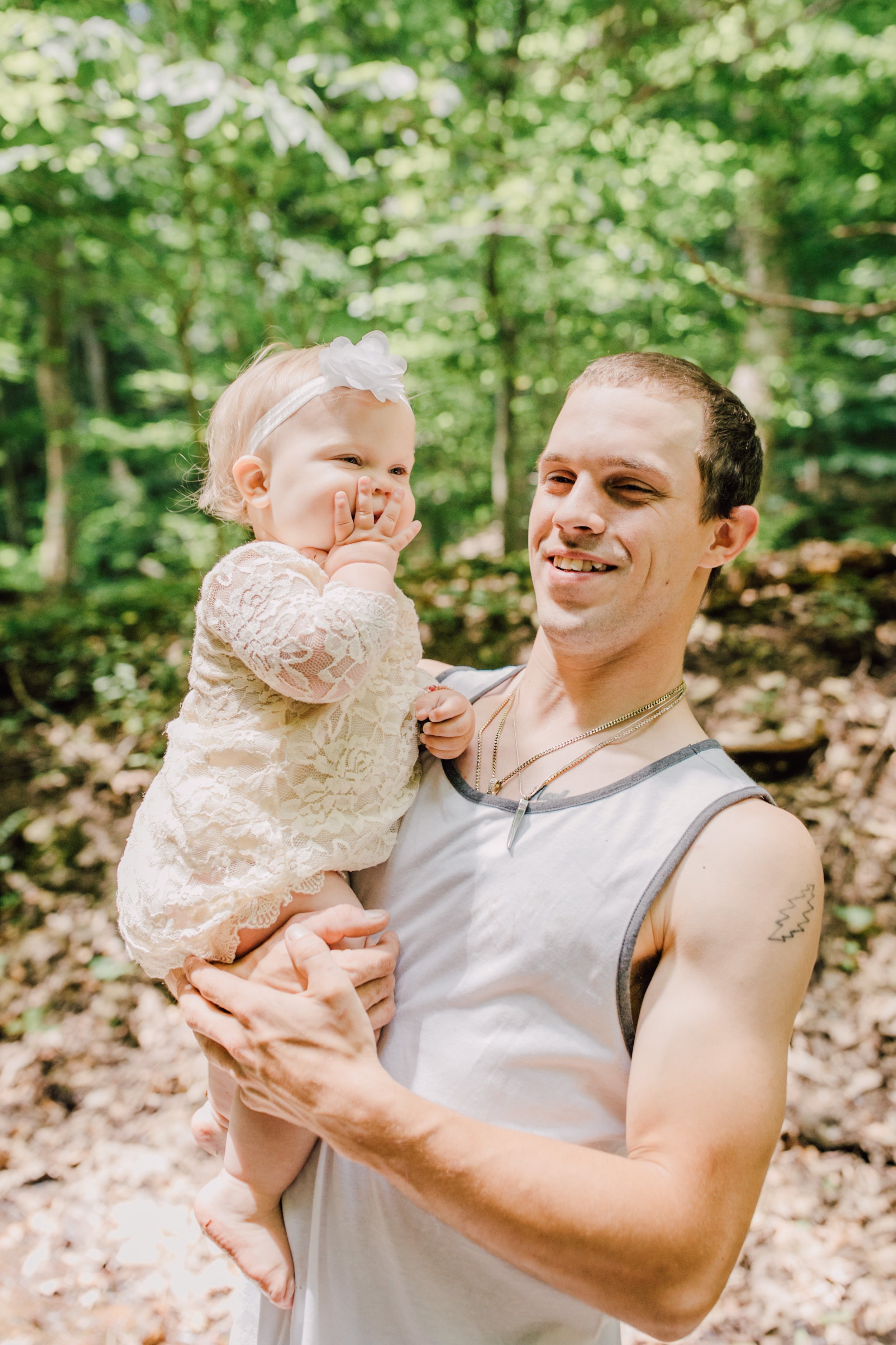  Dad holds his toddler as they smile during an adventure photoshoot&nbsp; 