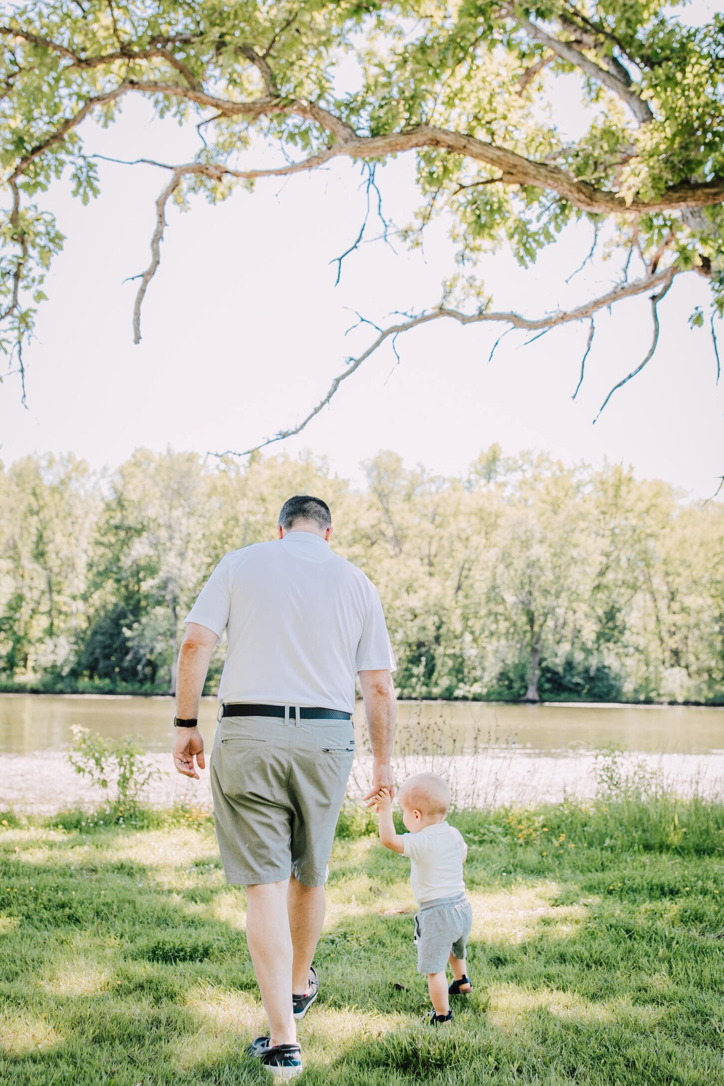 Father walks with his son during a family photo session 