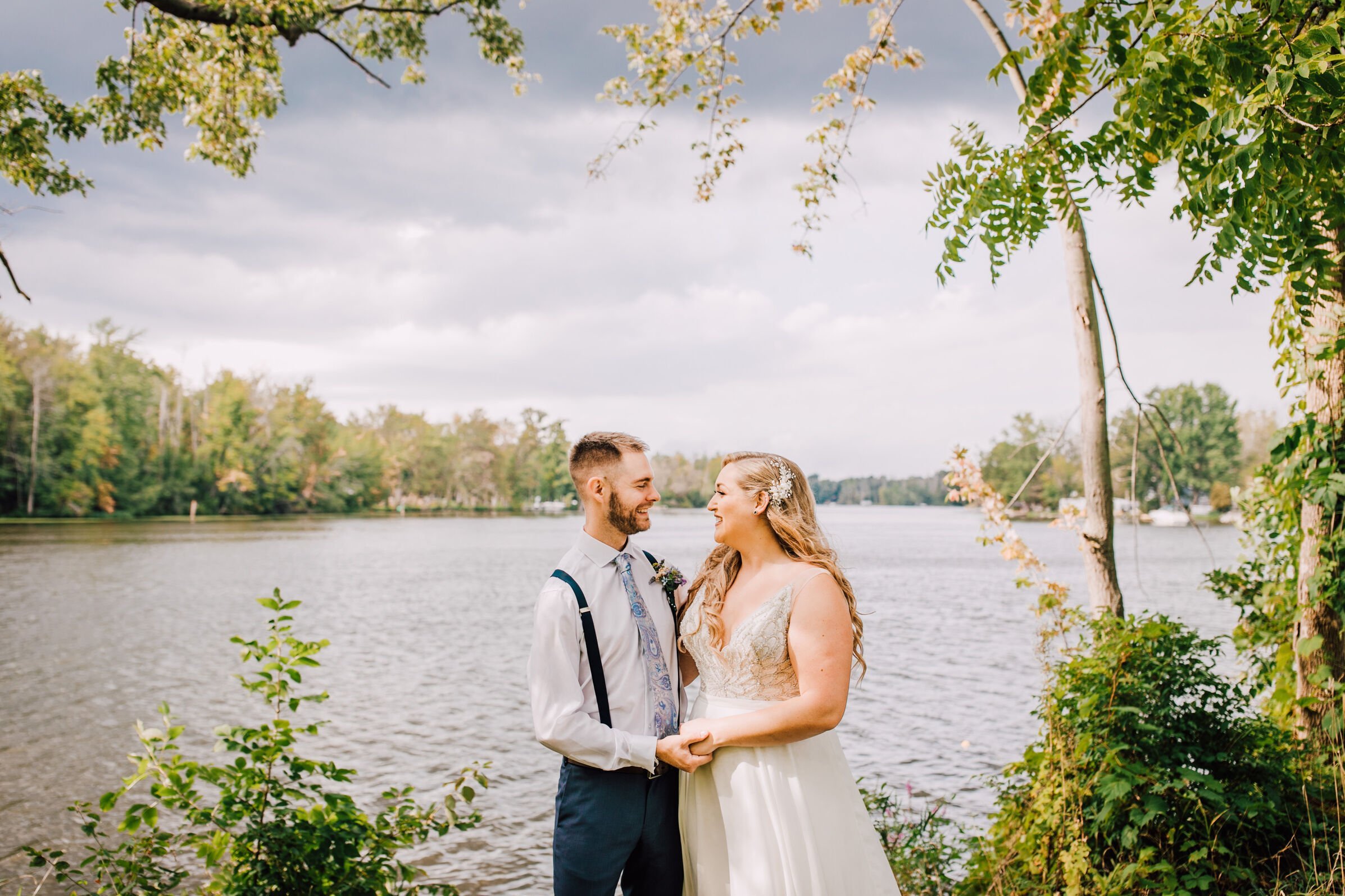  Bride and groom smile at each other during portraits at 3 rivers park 