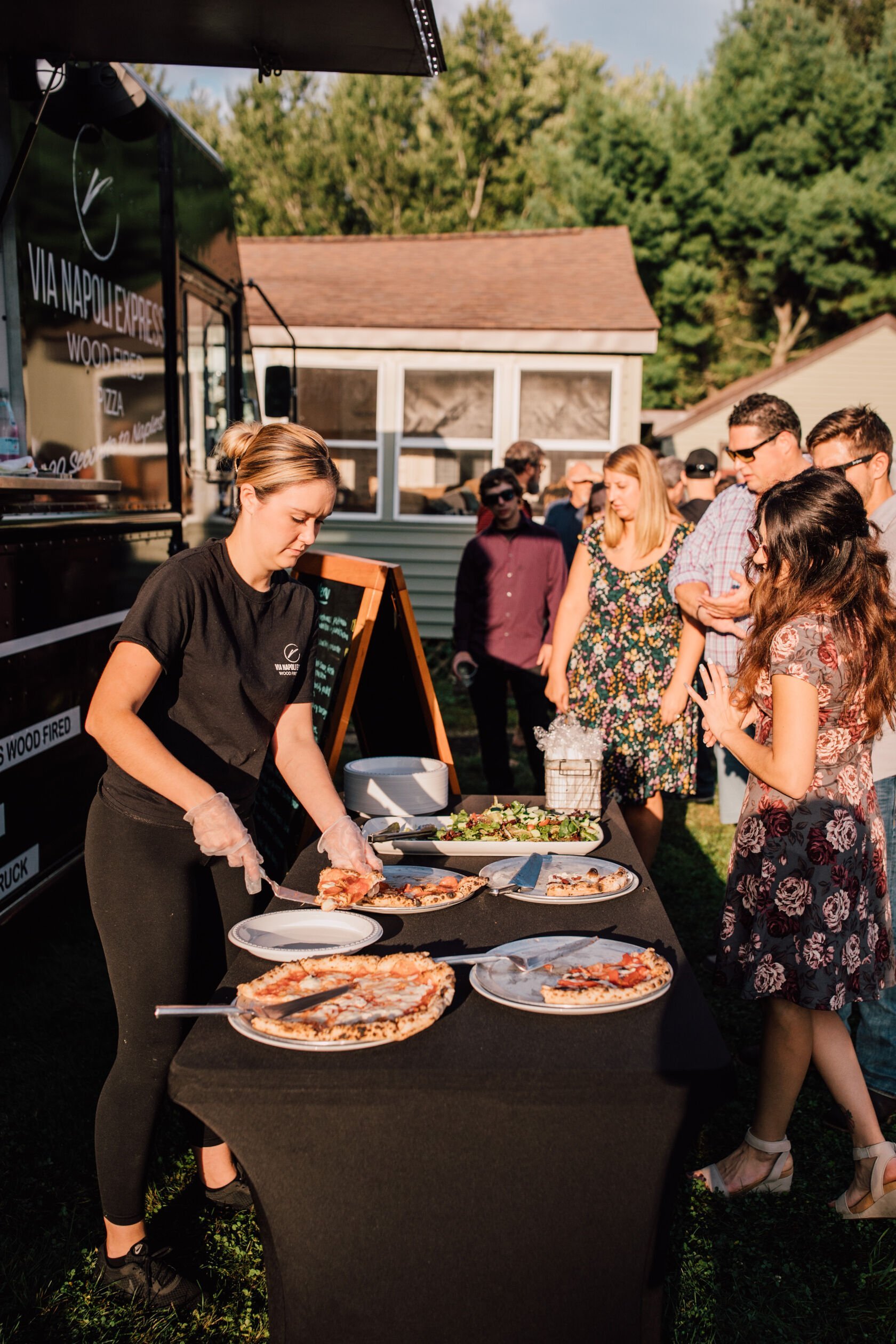  Via Napoli Express Food Truck serves guests at a backyard wedding reception 