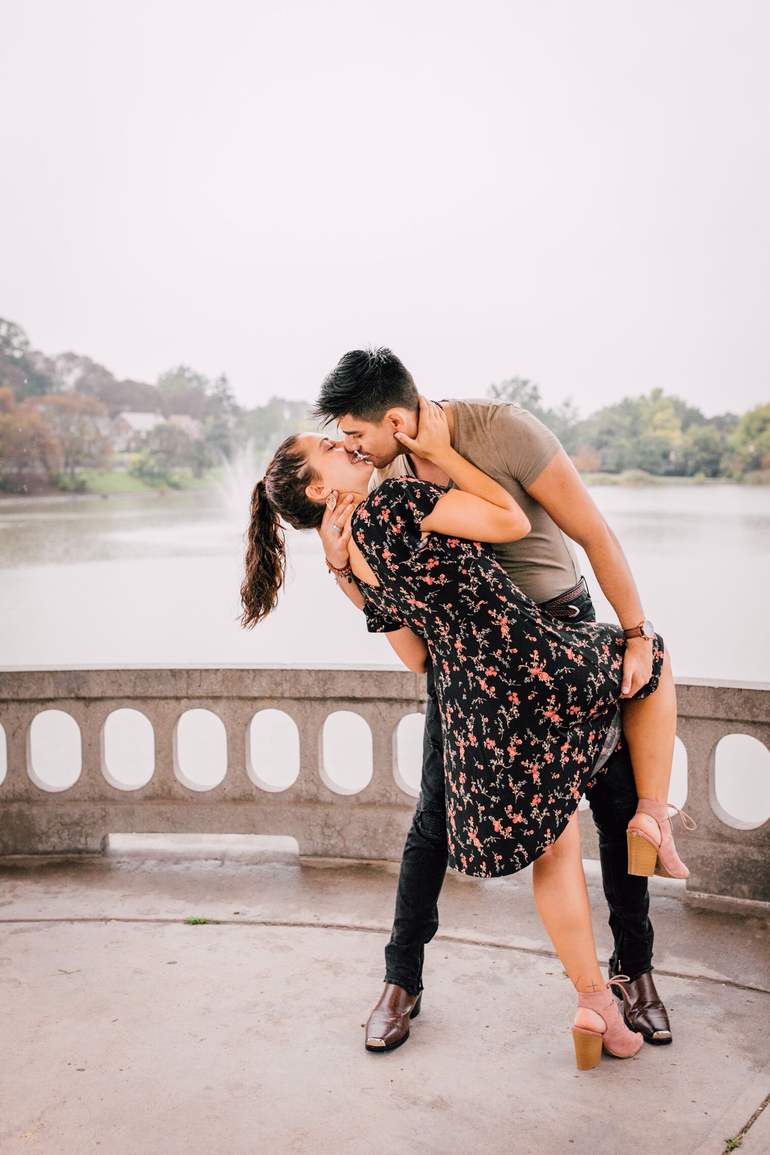  jessica and pablo kiss as they dance under a gazebo in front of a lake during their romantic photoshoot 