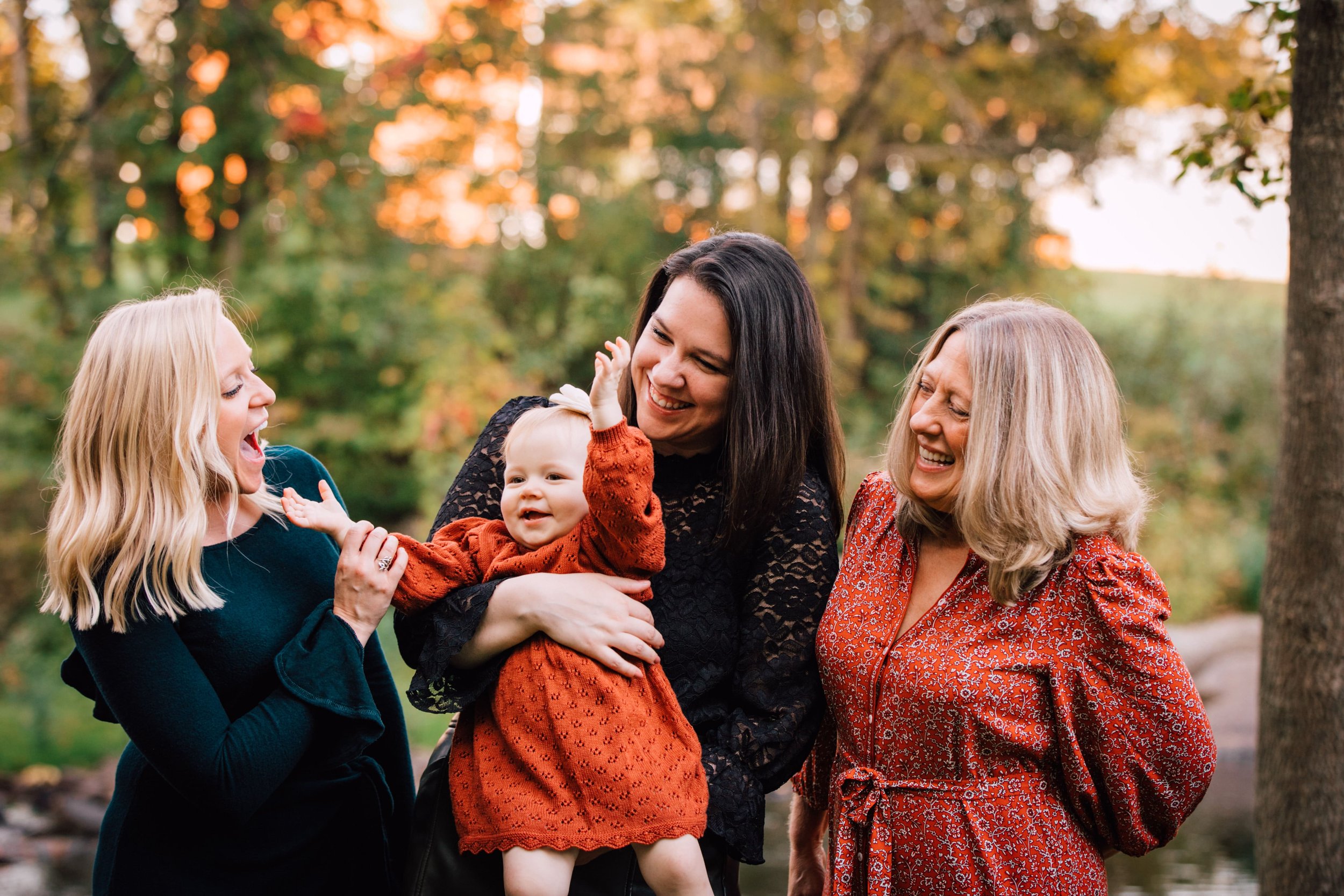  mom holds her baby while standing with her mom and sister during extended family portraits 