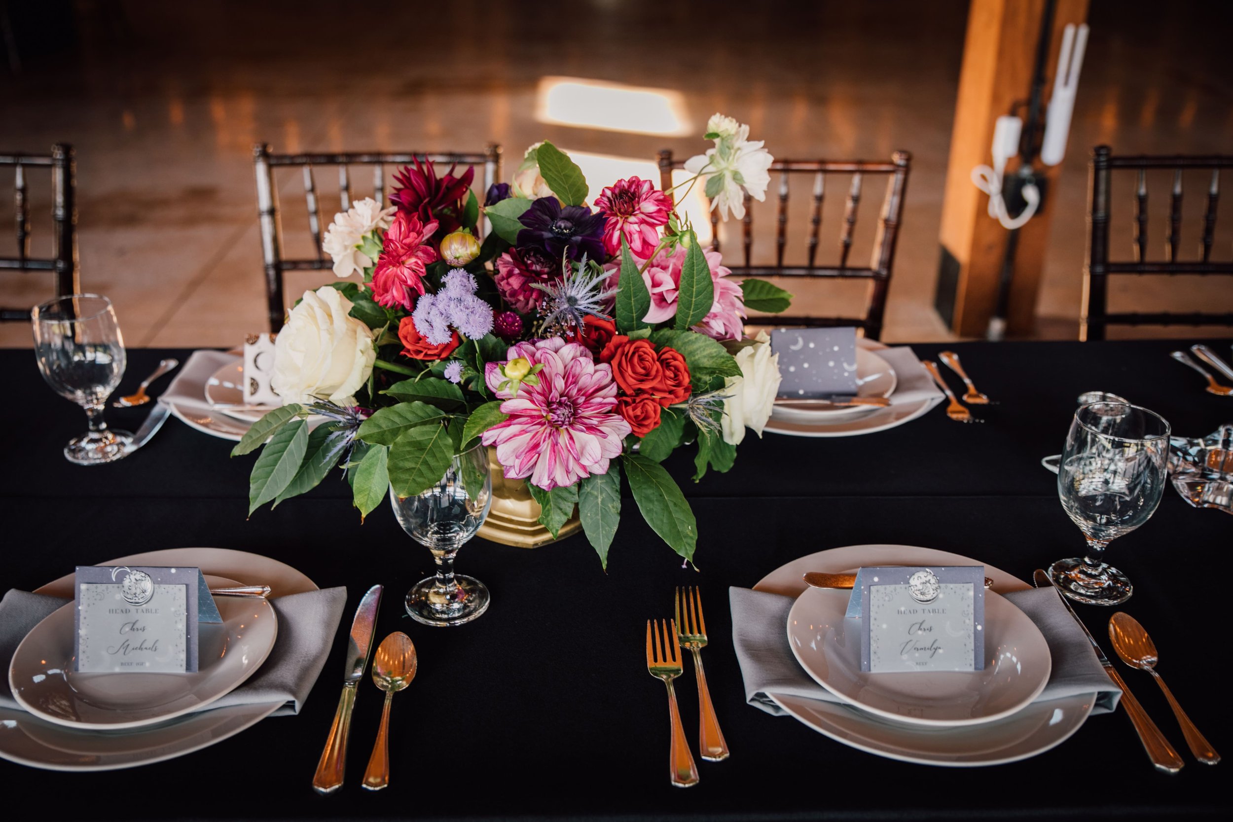  table centerpiece from a space wedding reception table with black tablecloth 