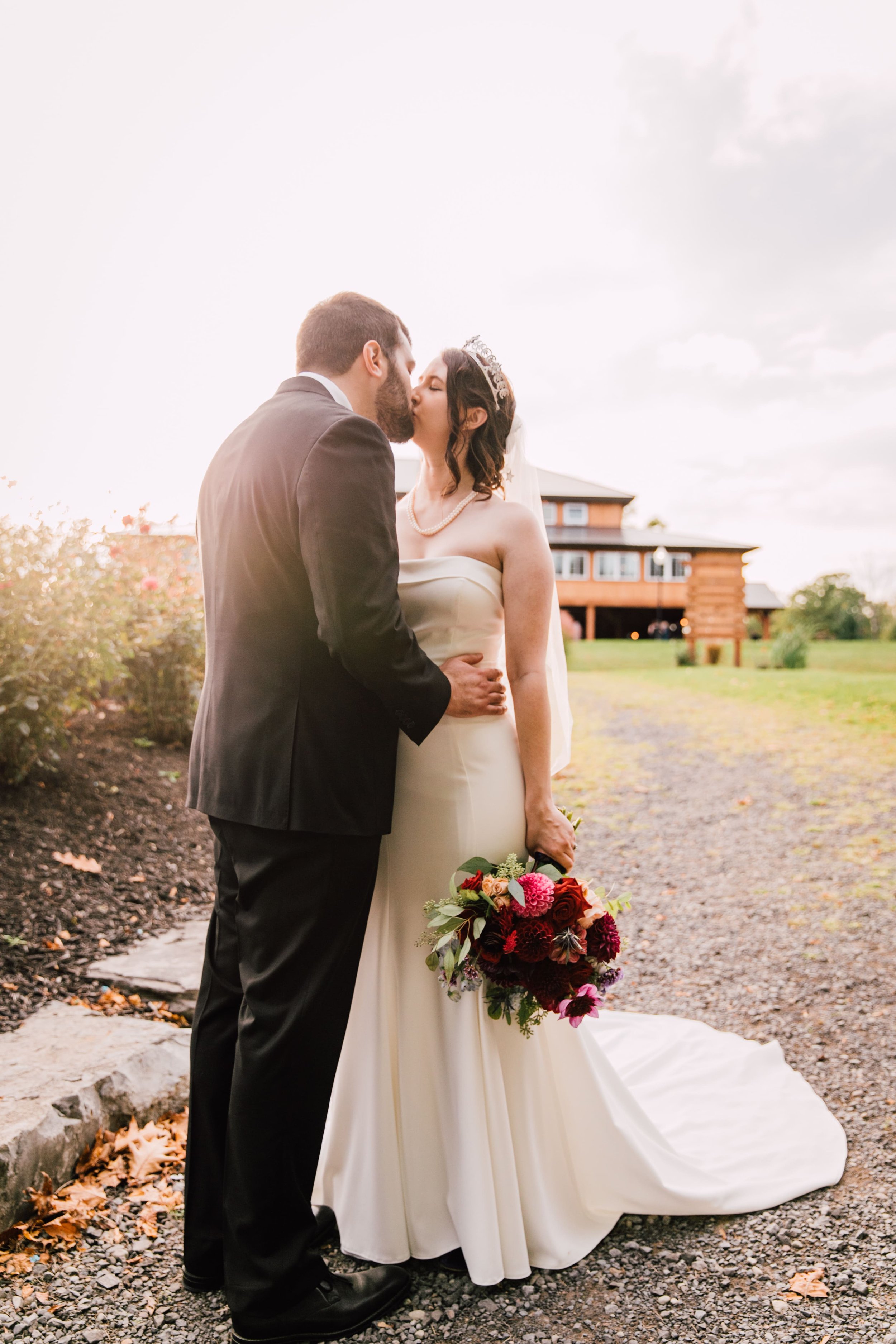  the bride and groom share a kiss in front of colloca estate winery 