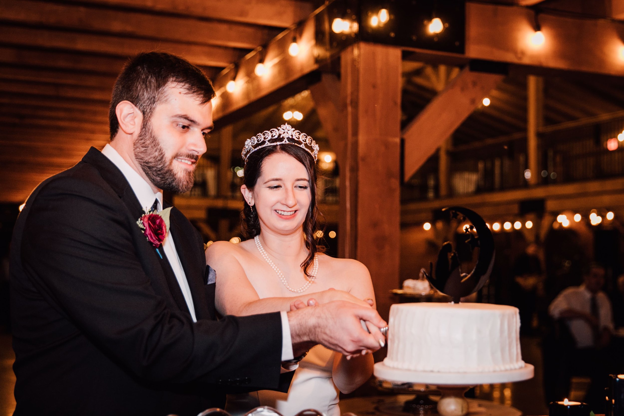  the bride and groom smile as they cut their celestial wedding cake 
