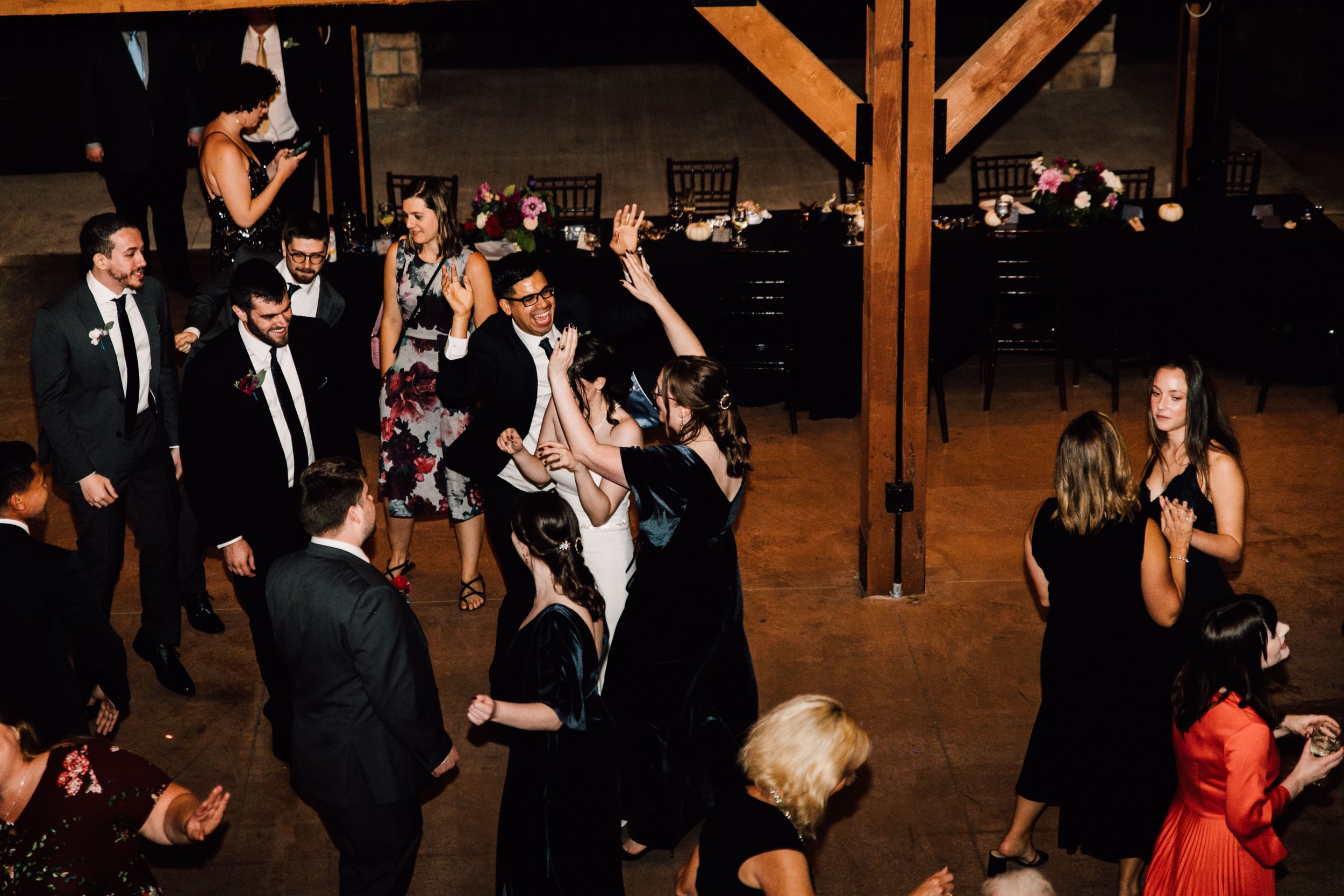  the wedding party and guests dance at a starry night wedding 