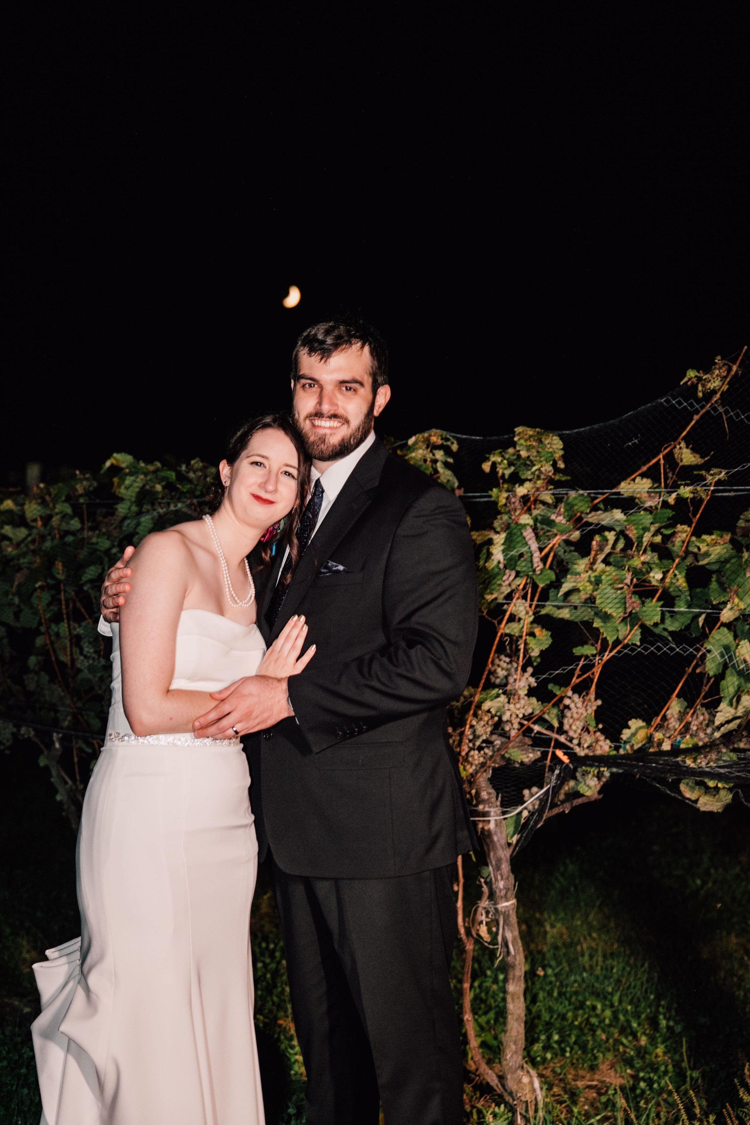 the bride and groom smile under the moon at their space wedding 