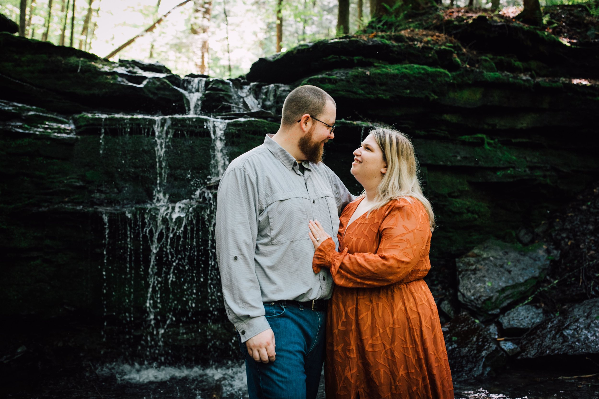  the engaged couple look at each other as they pose in central ny engagement photography 