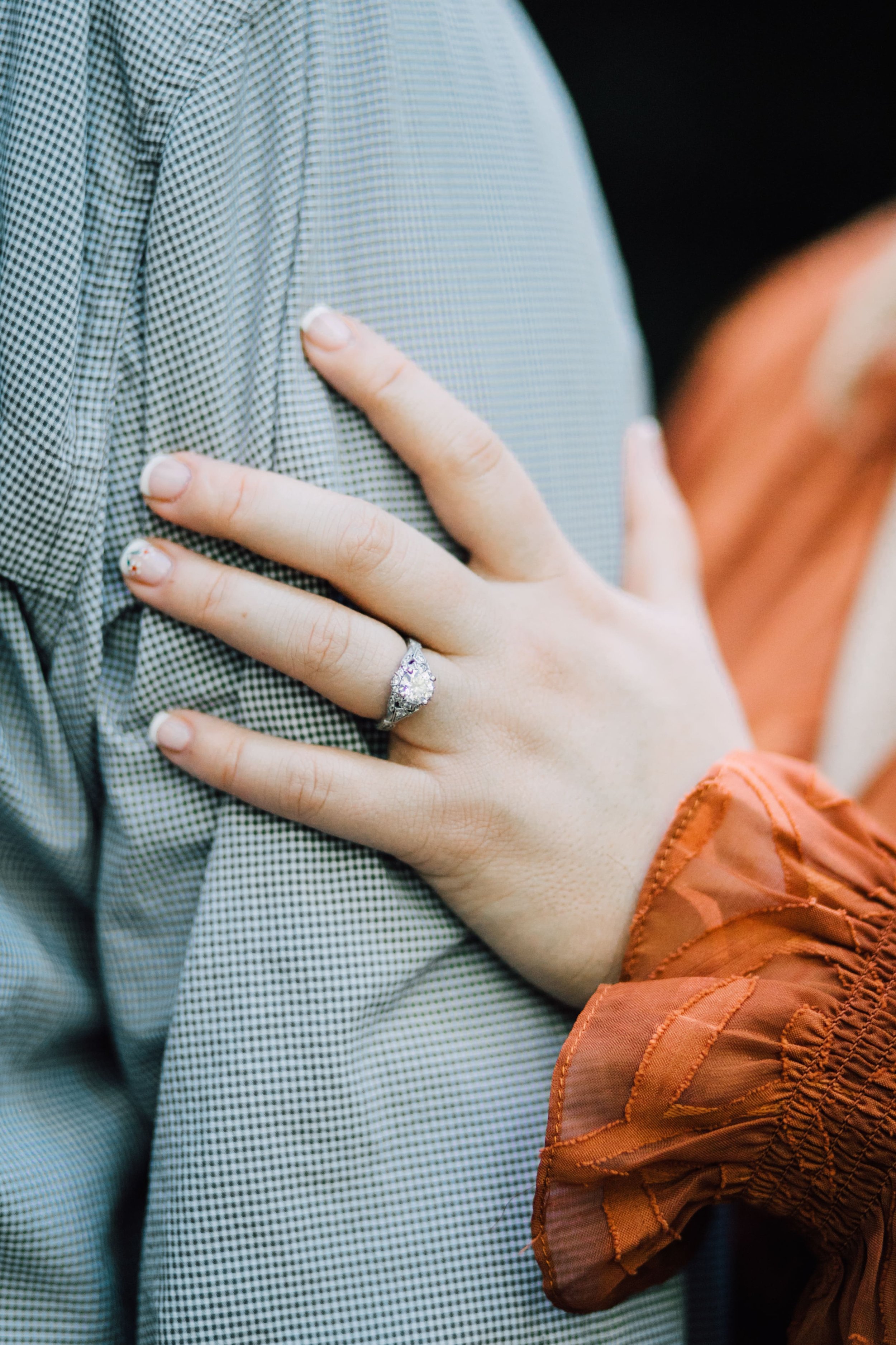  brittany rests her hand on patrick’s arm to show her engagement ring for central ny engagement photography 