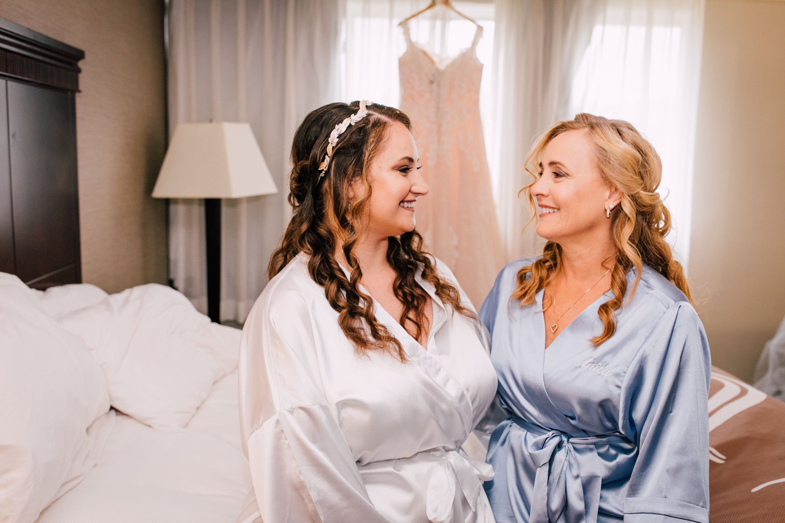  the bride smiles at her mother as they get ready for the day in matching robes in Endwell, NY 