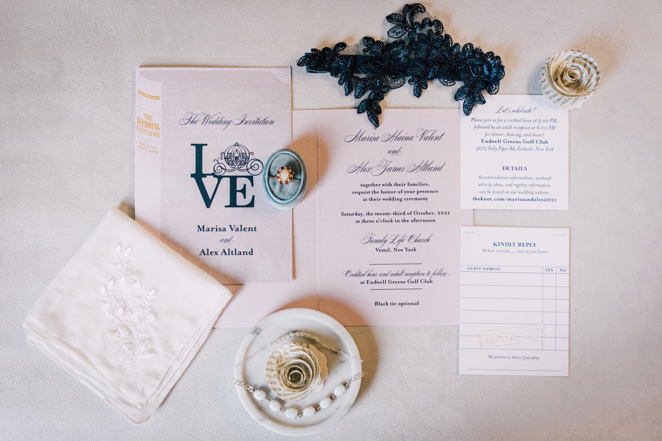  a flatlay of an invitation suite from a book themed wedding complete with a library card rsvp 