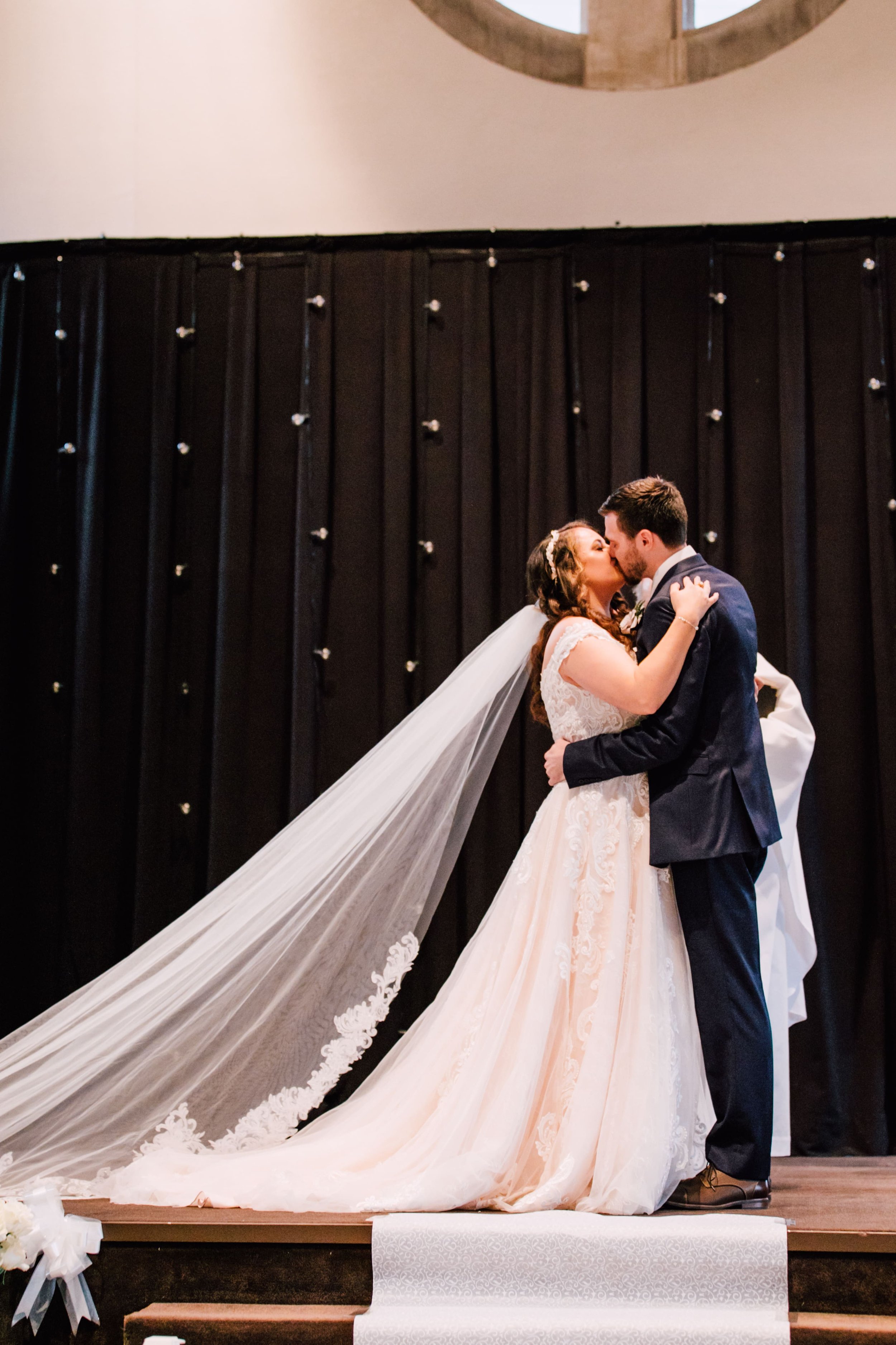  the bride and groom share their first kiss as husband and wife at their fall wedding ceremony 
