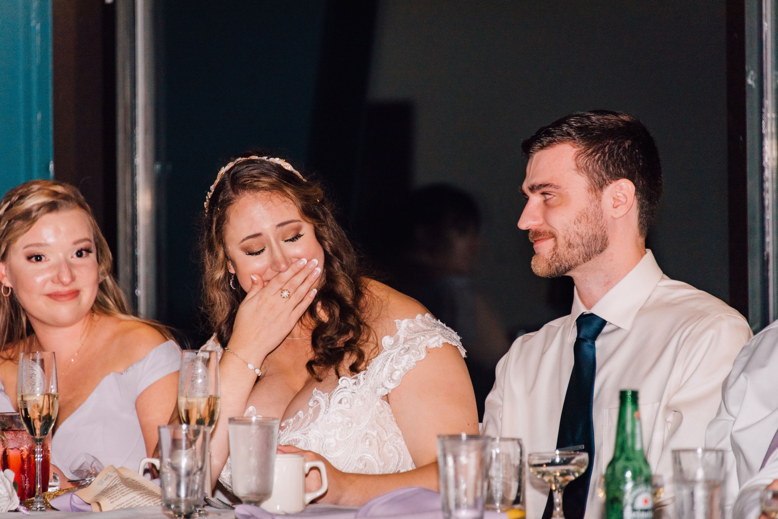  the bride and groom get emotional as a guest gives a speech during their wedding reception at endwell greens 