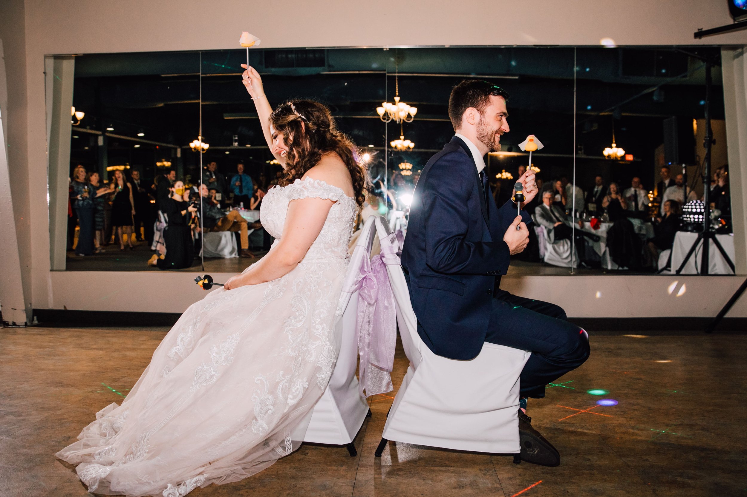  the bride and groom play the shoe game at their wedding reception at endwell greens 