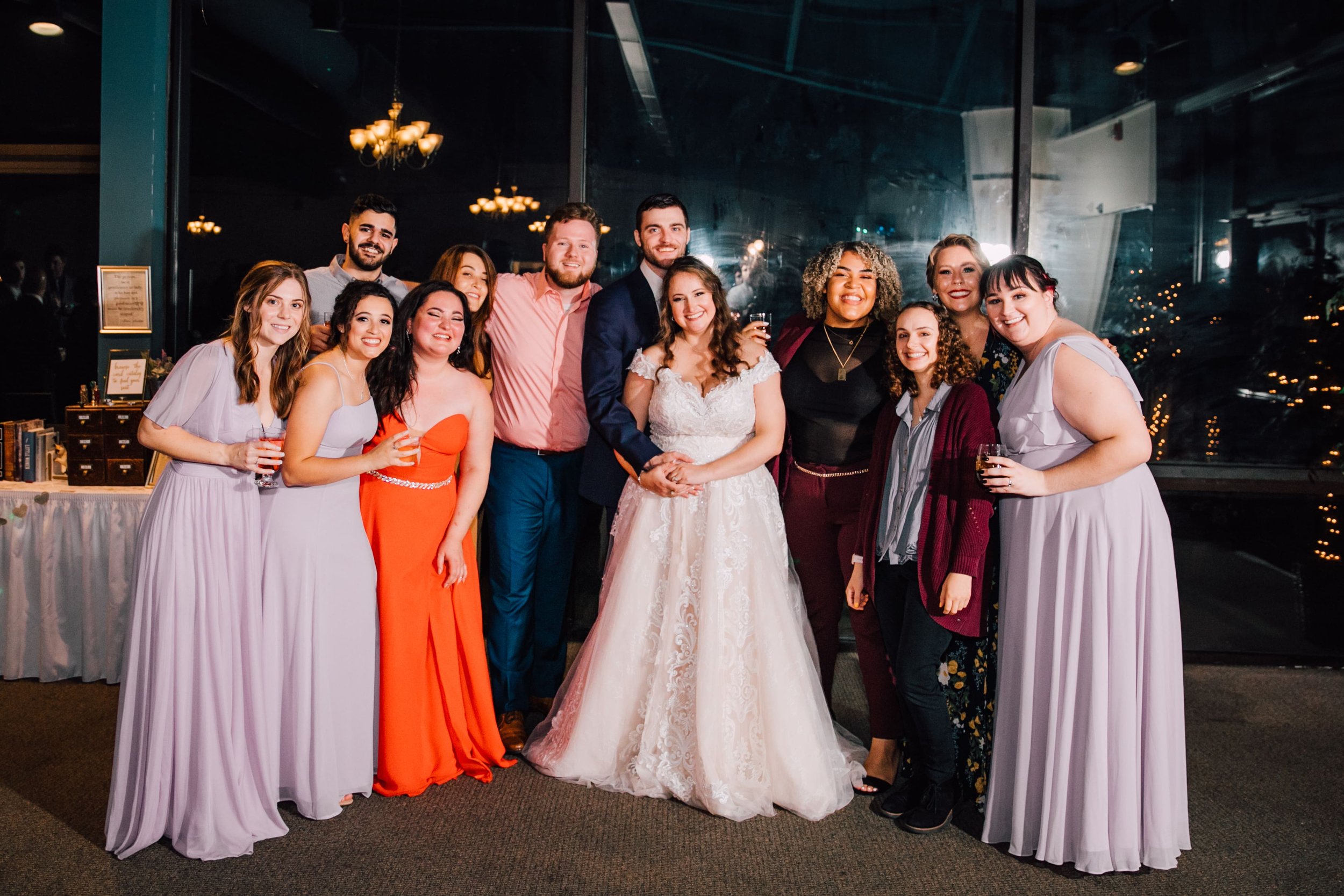  the bride and groom smile with their college friends, wedding photographer included, at endwell greens 