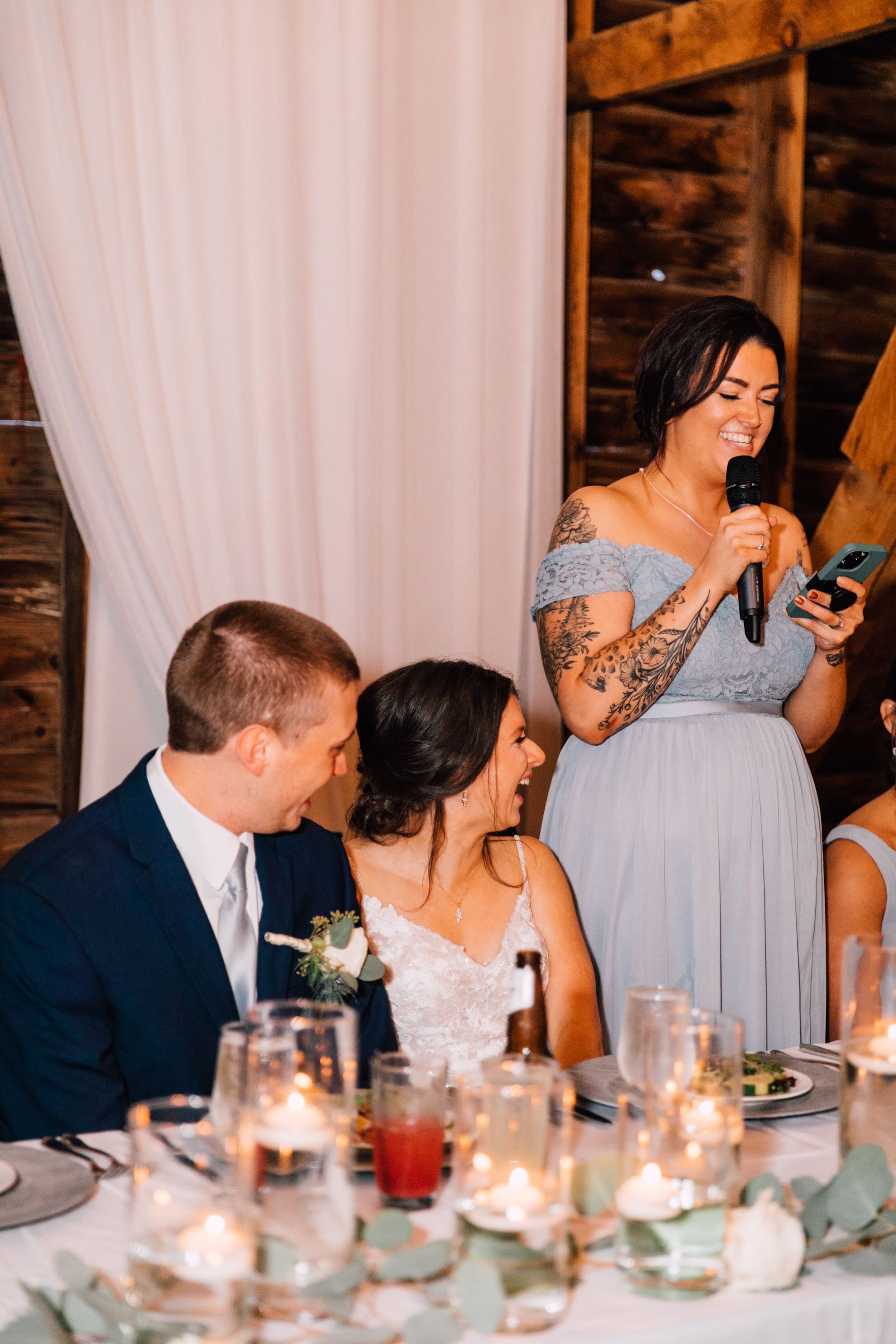  the maid of honor gives a toast at an elegant barn wedding 