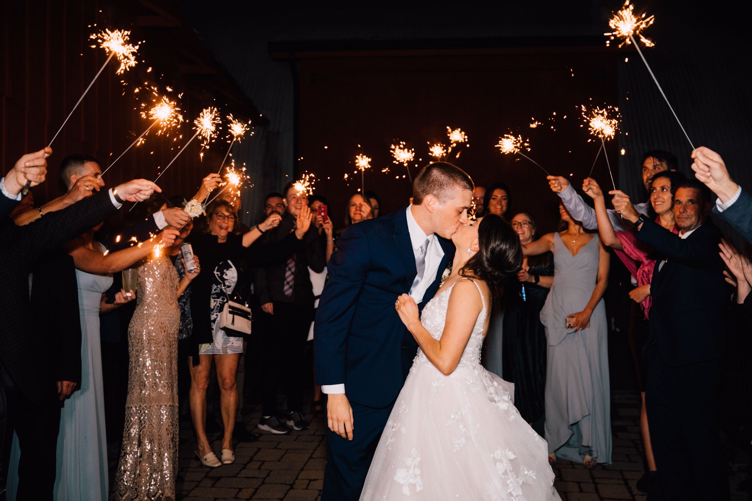  the bride and groom share a kiss during their sparkler exit 