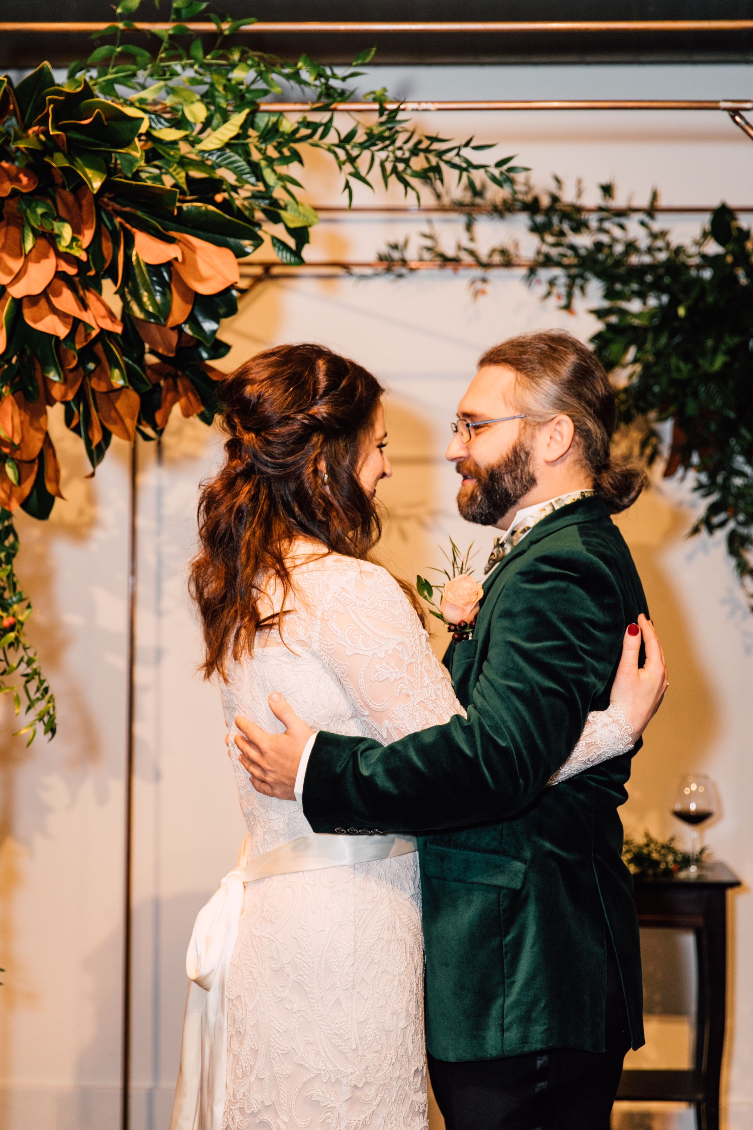  syracuse wedding photographer captures the moment after the newlyweds share their first kiss as they are in an embrace and smiling wide at each other 