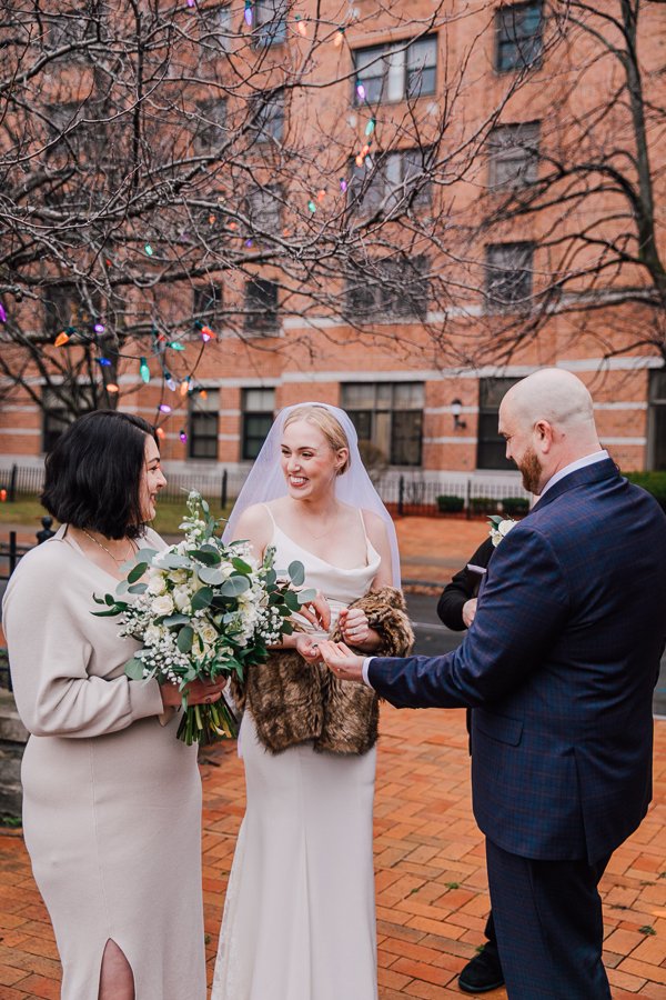  Witness hands rings to Bride and Groom while they elope upstate NY 