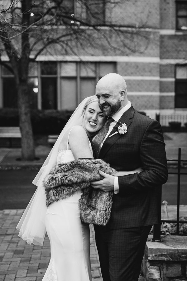  Bride and Groom hug immediately after wedding ceremony in Franklin Square Park Syracuse 