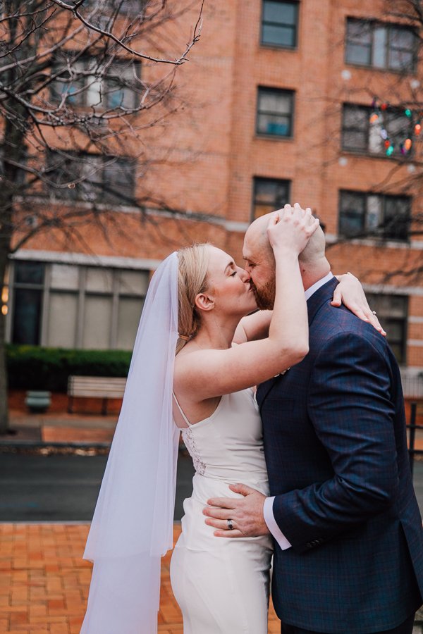  Bride and Groom embrace and kiss immediately after winter elopement in Syracuse, NY 