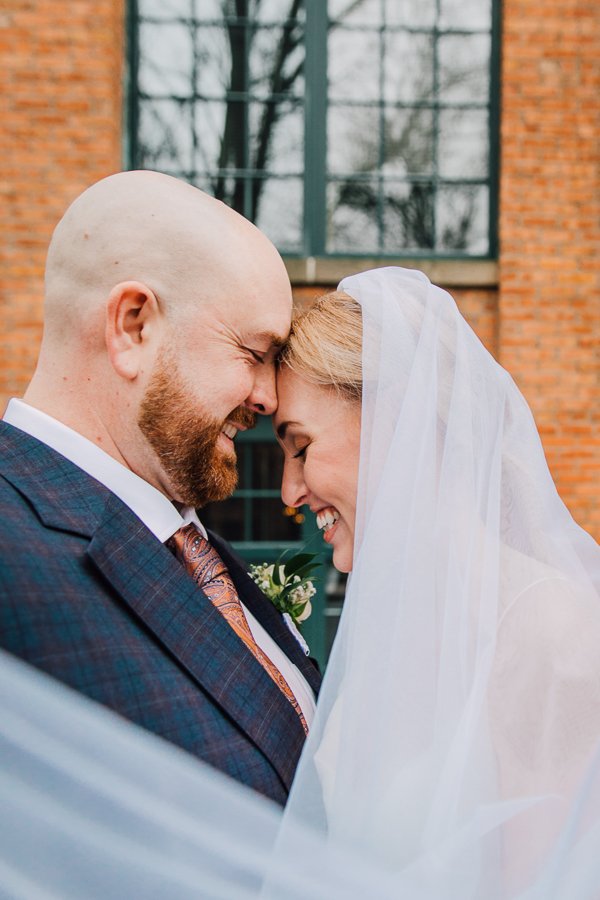  Bride and Groom cuddle close with a veil during upstate NY elopement  