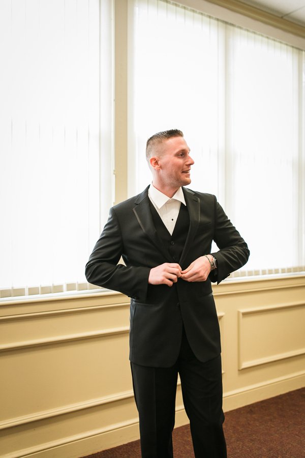  Groom putting his tux on and waiting for the ceremony to begin 