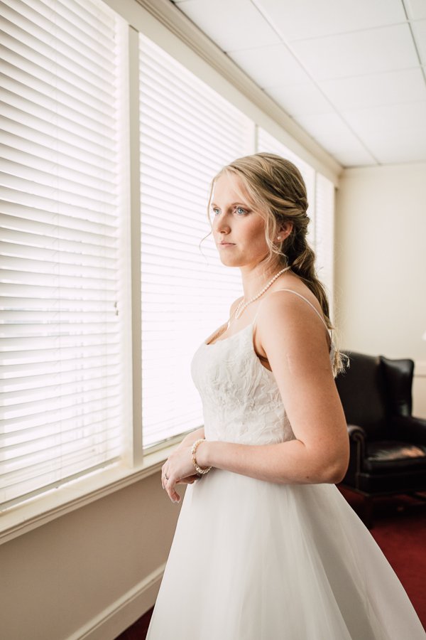  Bride putting her wedding dress on and waiting for ceremony to begin 
