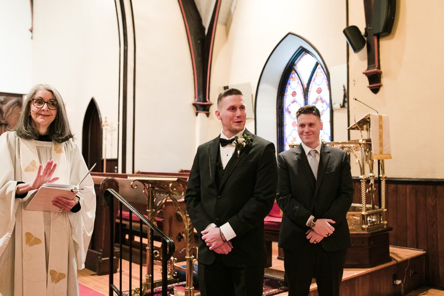  Groom tears up as Bride walks down the aisle at traditional church wedding ceremony in downtown Syracuse 