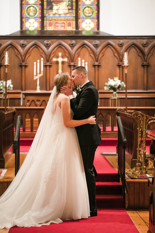  Bride and Groom’s first kiss at Trinity Episcopal Church wedding in Syracuse NY 