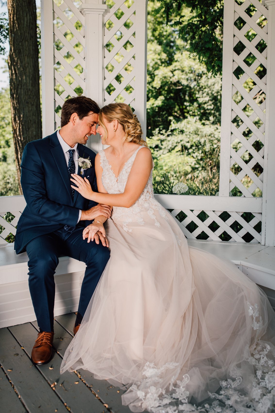  Bride and Groom cuddle up inside a gazebo at Windridge Estate Red Barn during their intimate central NY wedding 