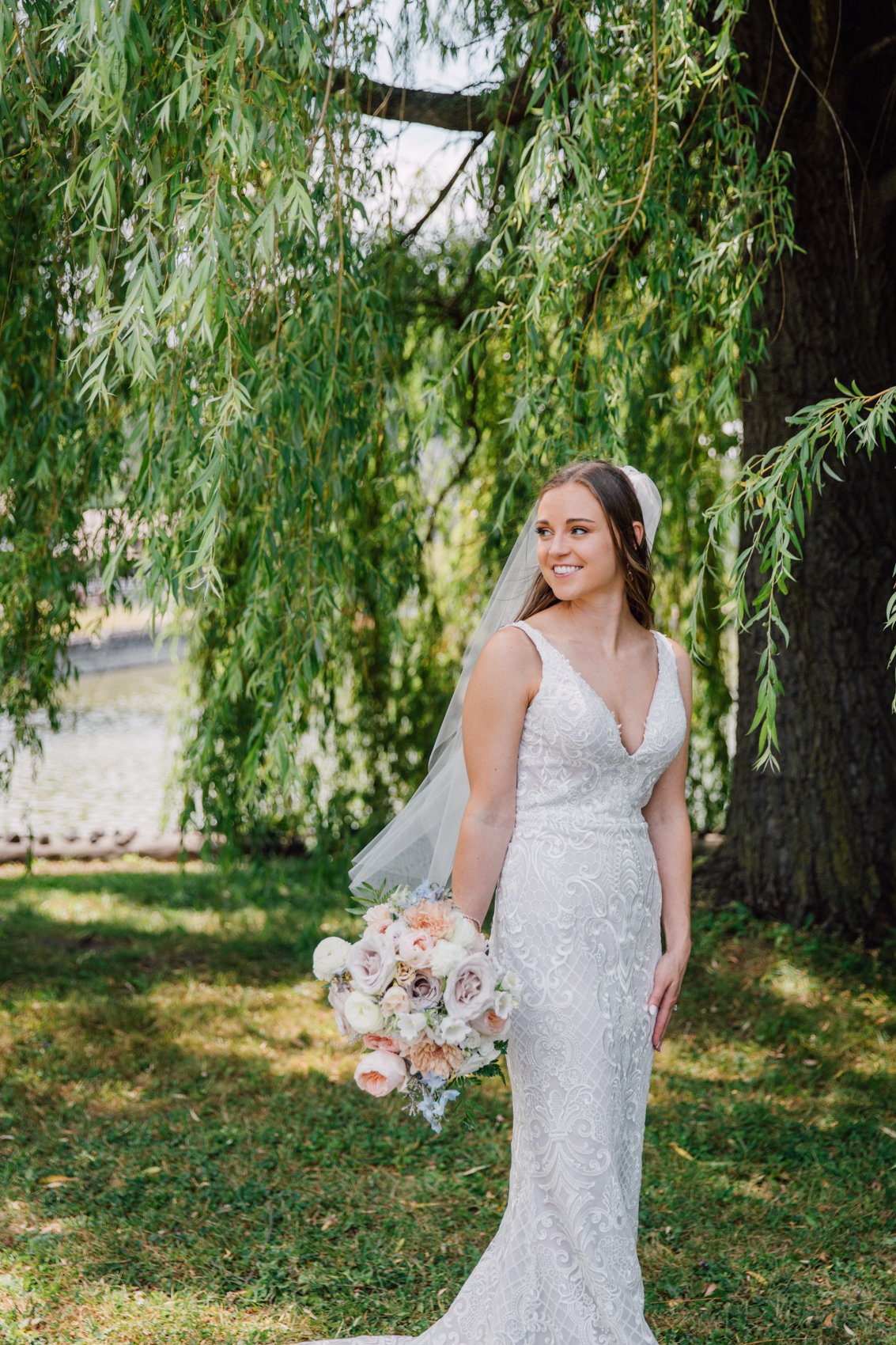  Bride smiles during wedding day portraits at Upper Onondaga Park in Syracuse NY 