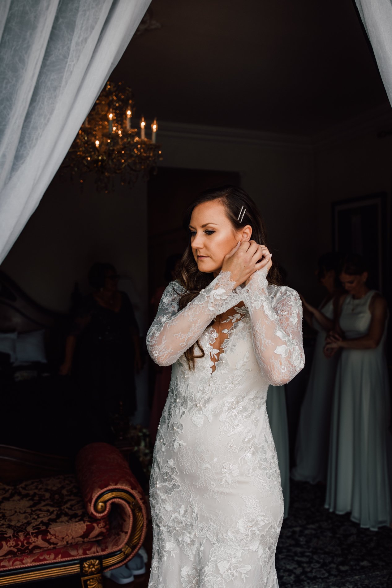  Bride puts in her earrings while getting ready for her outdoor wedding at the Inn at Taughannock Falls 