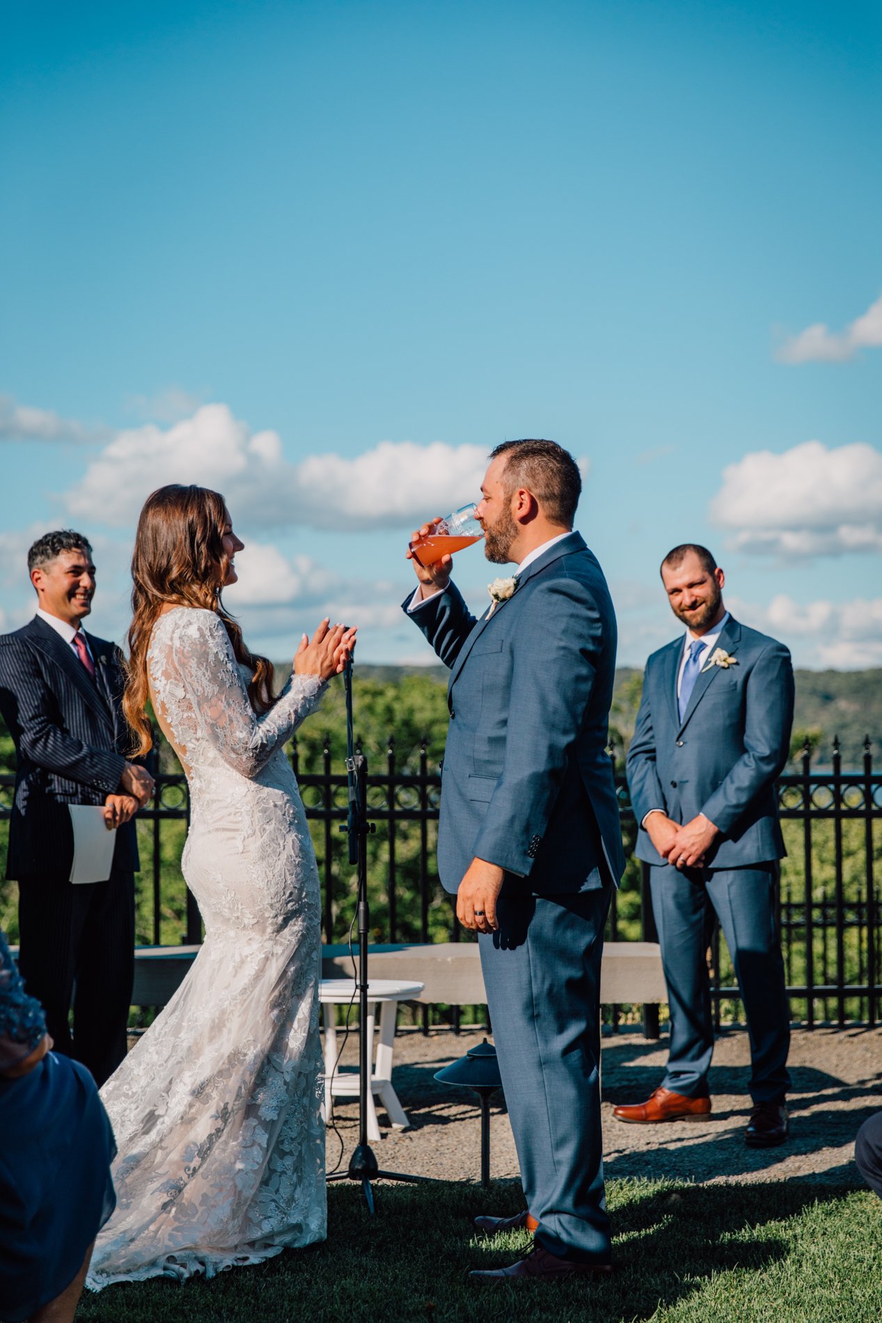  Groom drinks beer during beer ceremony at modern wedding at Taughannock Falls 