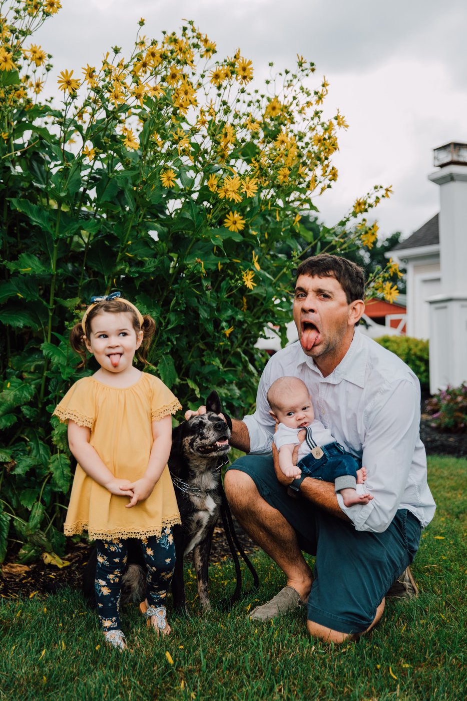  Father and daughter stick out their tongues during backyard family photos in Syracuse NY 