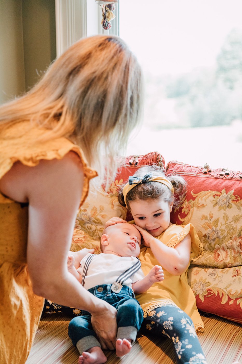  Big sister holds her newborn brother during newborn lifestyle photos by Brittany Juravich 