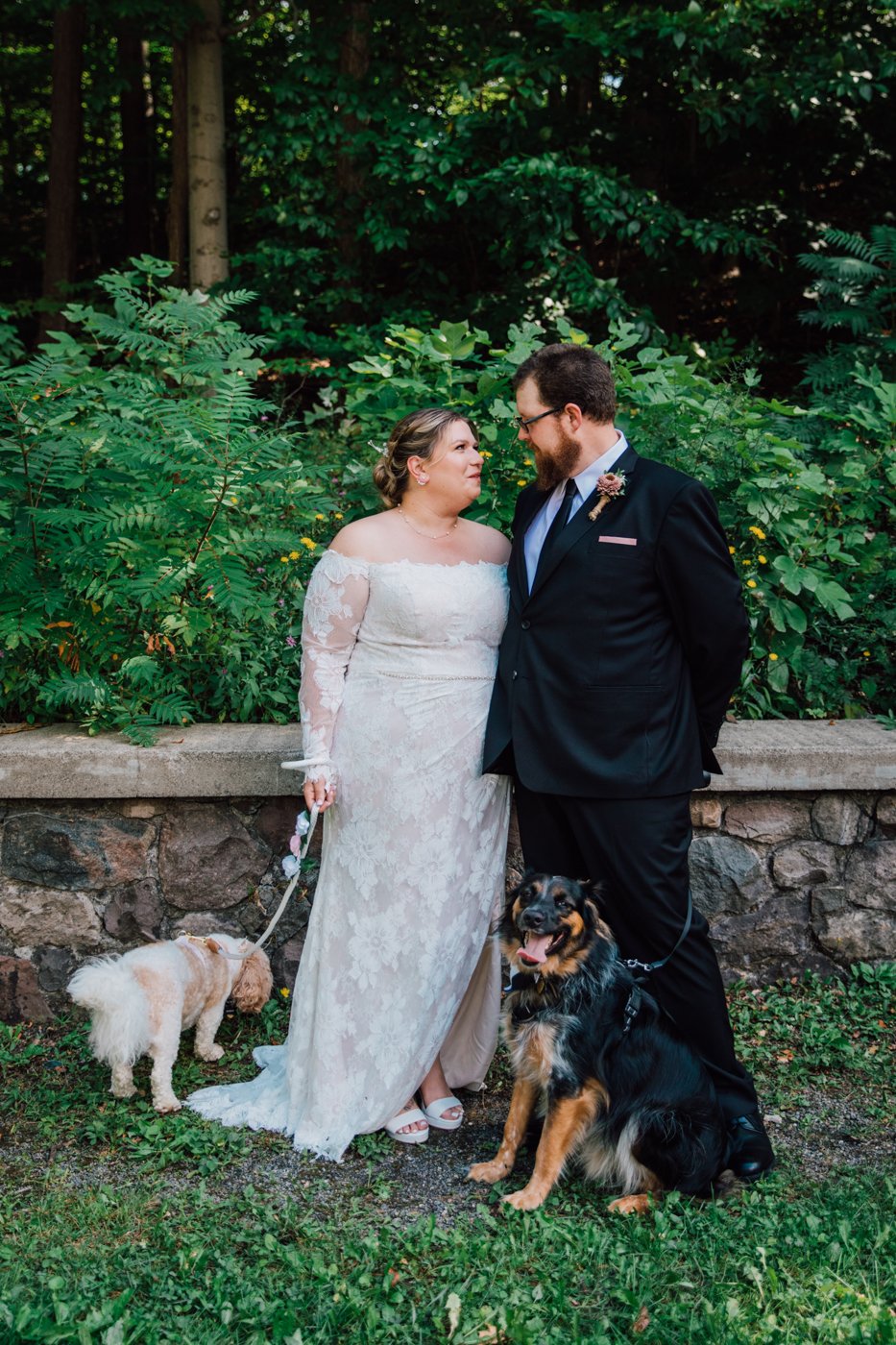  Bride and Groom stand with their dogs during a dog-friendly wedding at Green Lakes State Park 