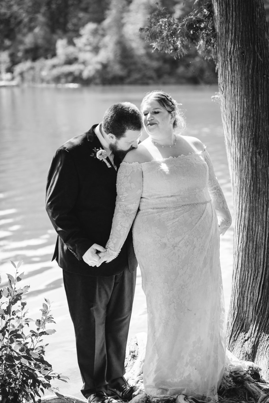  Groom kisses Bride on the shoulder during outdoor wedding photos with Brittany Juravich 