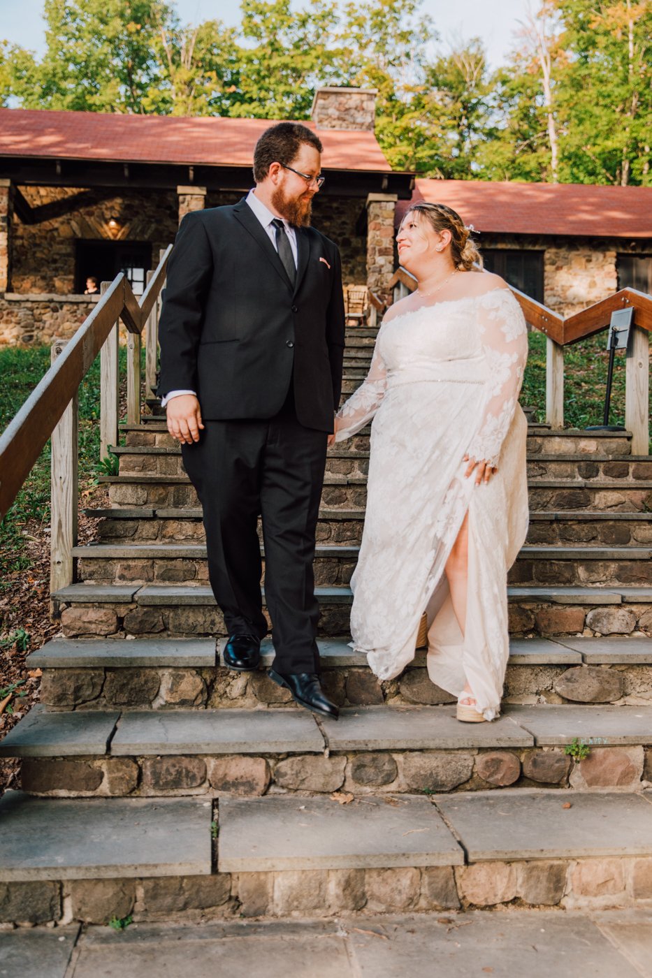  Newlyweds walk down a set of stone steps at Green Lakes 