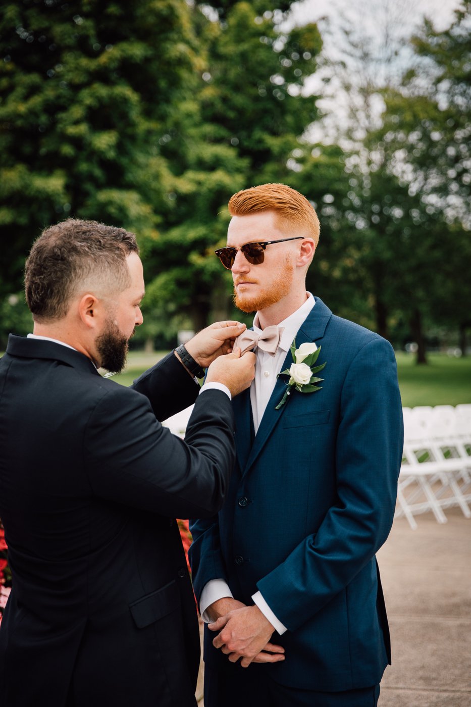  Groomsman straightens the Groom’s tie before his first look at Emerson Park Pavilion 