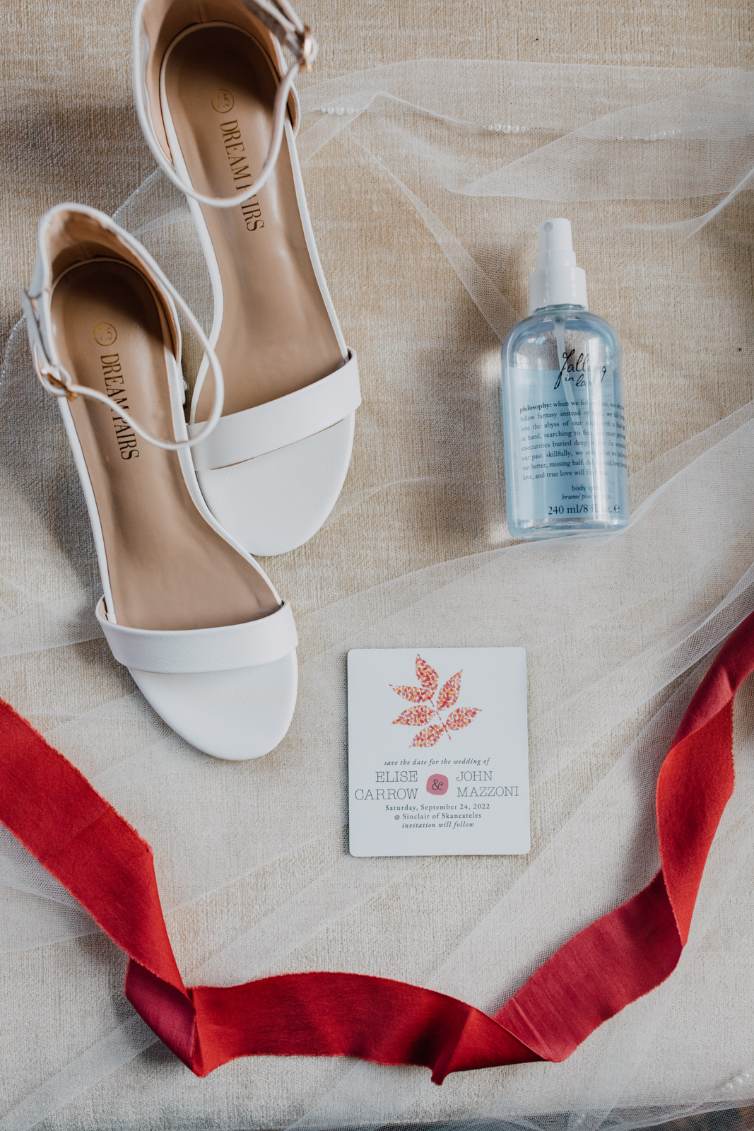  Layflat bridal details with shoes, ribbon stationery, and perfume 