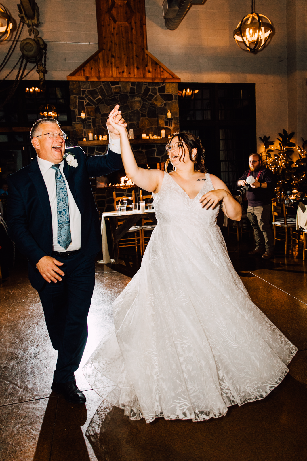  Bride dances with her father while they twirl and laugh at her Sinclair of Skaneateles wedding reception 