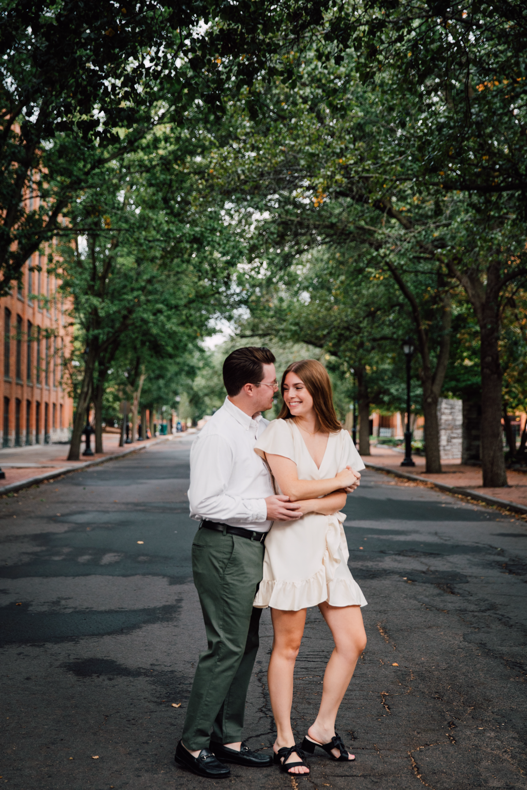 Engaged couple embraces in the middle of the street in downtown Syracuse during their engagement session 